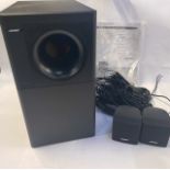 A Bose Acoustic Mass system speaker, 3 Series IV, serial no 024303333510569AC, and two additional sm