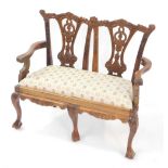 A Chippendale style mahogany miniature sofa, with leaf carved crest rail, harebell carved vase