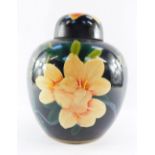 A 20thC Chinese Republic pottery ginger jar and cover, painted with orange flowers orange flowers an