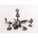 A group of white metal Eastern figures, buildings and trinkets, to include fishing figures, sailing