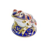 A Royal Crown Derby frog paperweight, seated on blue ground, silvered stopper, 9cm high, boxed.