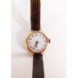 A lady's 9ct gold wristwatch, with circular wristwatch head on white enamel dial, with gold outer co