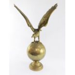 A mid 20thC brass figure group, of an eagle perched on globe, on a stepped base, 65cm high.