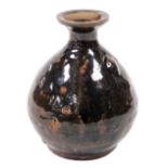 A West Country type glazed pottery bottle, of globular form, with a fixed seal to the neck, slip gla