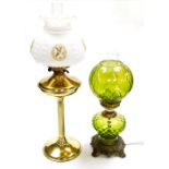 A 20thC brass effect oil lamp with shade, 69cm high, and a table lamp of oil lamp form, with green g