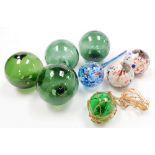 A collection of coloured glassware, to include various green glass orbs, 13cm wide, two mottled glas