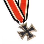 A World War II Third Reich iron cross, dated 1939, on a later ribbon.