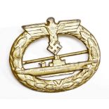 A Third Reich U-boat submarine badge, cast with eagle, swastika and submarine, 5.5cm wide.