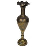 An Eastern floor standing vase, with a flared rim, the body decorated with etched brass decoration o