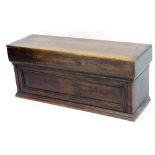 A pine and oak blanket chest, the front with a carved panel, on a plinth base, made from a variety o