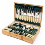 An oak canteen of silver plated cutlery, with angular tapering handles, comprising table cutlery, fi