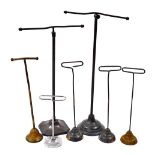 A group of early 20thC adjustable shop stands of various types, the largest 36cm high.