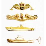 A group of submarine badges, to include an America submarine pin badge, cast with a submarine flanke