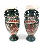 A pair of Japanese Satsuma earthenware vases, each decorated with a geisha and flowers against a gre