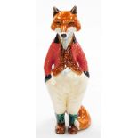 A Rye pottery fox figure, of a gentleman fox in red waistcoat, signed LB, 23cm high. We have speci