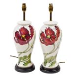 A pair of Moorcroft pottery Dancing Flame table lamps, of baluster form, against a cream ground, on