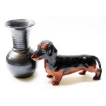 A Beswick model of a Dachshund, 22cm wide, and a Prinknash pottery black lustre vase of baluster sho