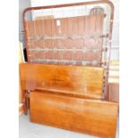 An early 20thC walnut double bed frame, comprising headboard and foot, bed base and supports. Lots 1