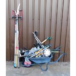 A quantity of garden tools, to include wheelbarrow, various spades, a tree lopper, rake, garden brus