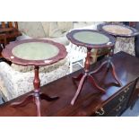 Three mahogany wine tables, each with a leather inset top and pie crust border, the tallest 50cm hig