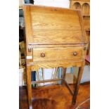 An oak bureau on stand, the fall enclosing a fitted interior above a frieze drawer, 99cm high, 52cm
