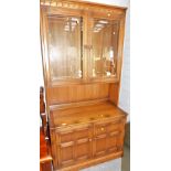 An Ercol dresser, the top with two glazed doors above two cabinets, 194cm high, 97cm wide, 50cm deep