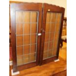 An oak display cabinet, with two leaded glazed doors, 86cm high, 73cm wide, 22cm deep.