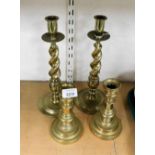 Two pairs of brass candlesticks, 32cm and 18cm high respectively.
