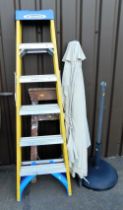 A Werner A frame step ladder, a further wooden step ladder, and a garden parasol.