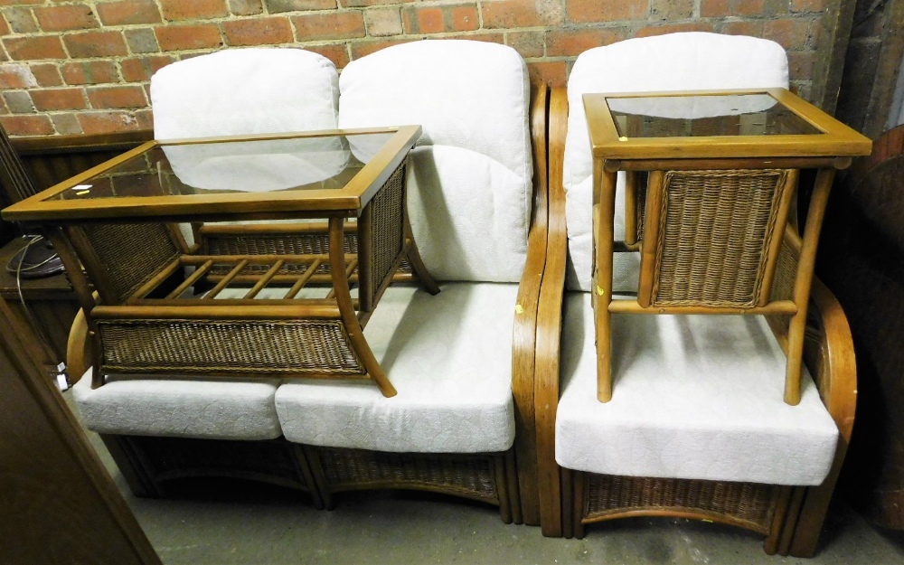 An oak framed conservatory suite, comprising two seater sofa, armchair, and two coffee tables, each