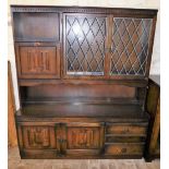 An oak dresser, with lead glass panel doors aside a linen fold fall front above linen fold panel, cu
