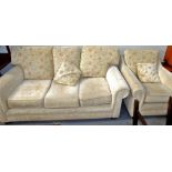 A modern three seater sofa and associated armchair. The upholstery in this lot does not comply with