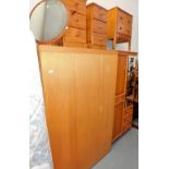 A group of furniture, to include a G Plan triple wardrobe, a pair of pine three drawer bedside chest