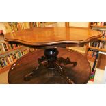 An Italian style occasional table, with marquetry inlaid decoration, with a shaped top on four carve