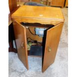 A teak sewing machine table, containing a Pfaff sewing machine.