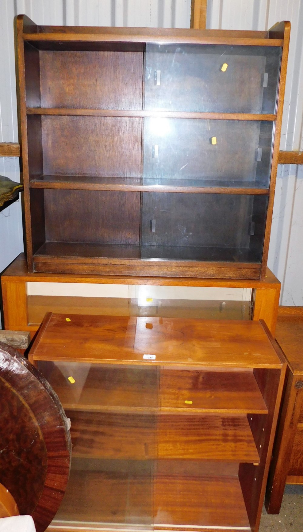 Three various bookcases, each with sliding glass doors.