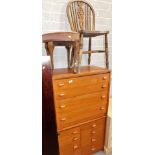A mid 20thC teak four drawer chest, 69cm high, 78cm wide, 45cm deep, a wheel back dining chair, etc.