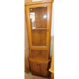 An oak corner cabinet, 173cm high.