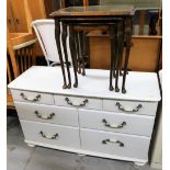 A white painted chest of drawers, with an arrangement of drawers, 71cm high, and a nest of tables.