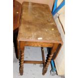 An oak barley twist drop leaf table.