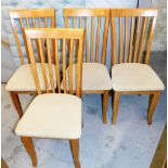 A set of four beech lath back dining chairs, with beige upholstered seats.