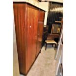 A Stag Minstrel bedroom suite, comprising two double wardrobe, four drawer bedside chest, double hea