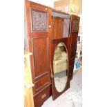 An Art Nouveau double wardrobe, lacking cornice with two Art Nouveau inlaid doors, and an oval mirro