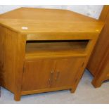 A modern light oak side cabinet, with a recess above two hinged doors, 76cm high.