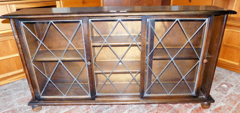 A 20thC oak bookcase, with astragal glazed door, 74cm high, 133cm wide, 28cm deep.