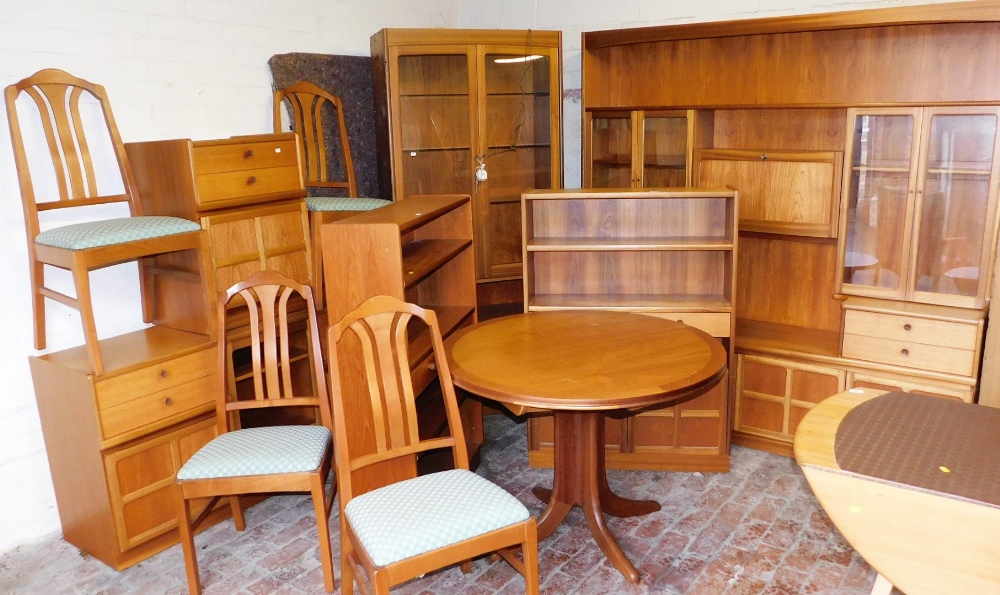 A comprehensive Nathan style suite of dining furniture, comprising a pair of open bookcases, 125cm h