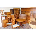 A comprehensive Nathan style suite of dining furniture, comprising a pair of open bookcases, 125cm h