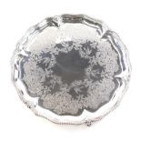 A Victorian silver waiter, of piecrust form with a beaded outline etched interior on claw and ball f
