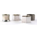 Four various silver napkin rings, to include a George VI Sheffield example, of circular engine turne