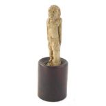 An unusual soapstone carving of an Egyptian figure, on a cylindrical wooden base, partially signed,